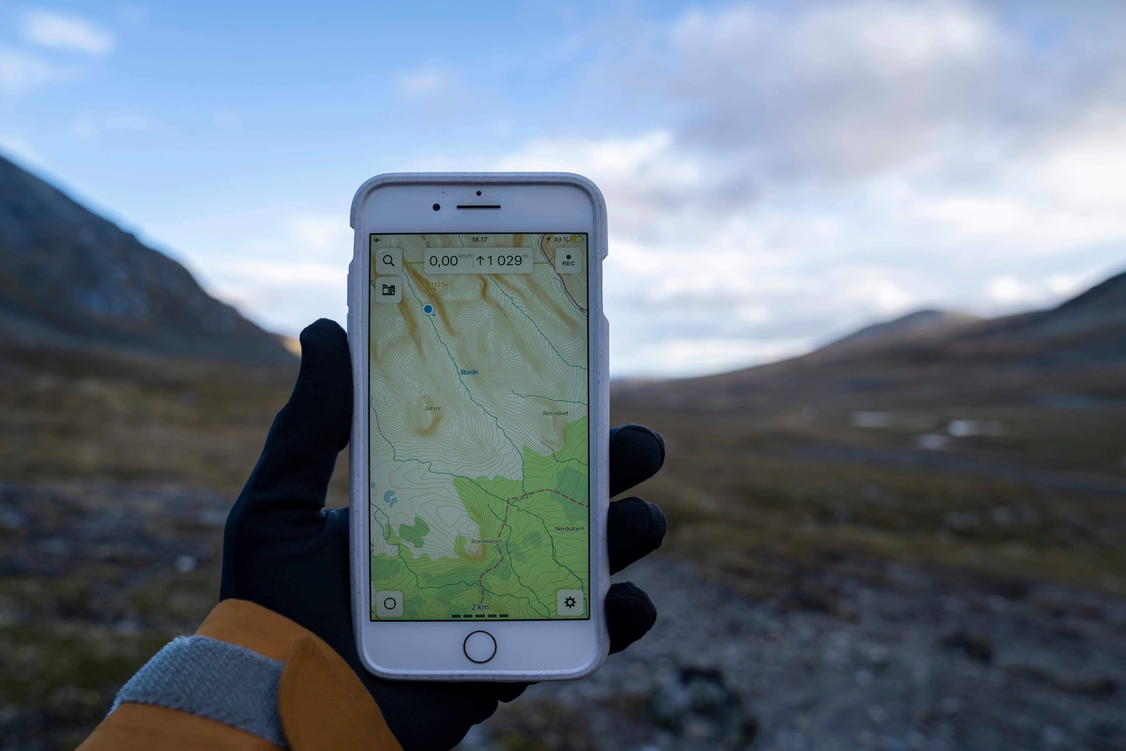 Hiker navigating with GPS device on a mountain trail