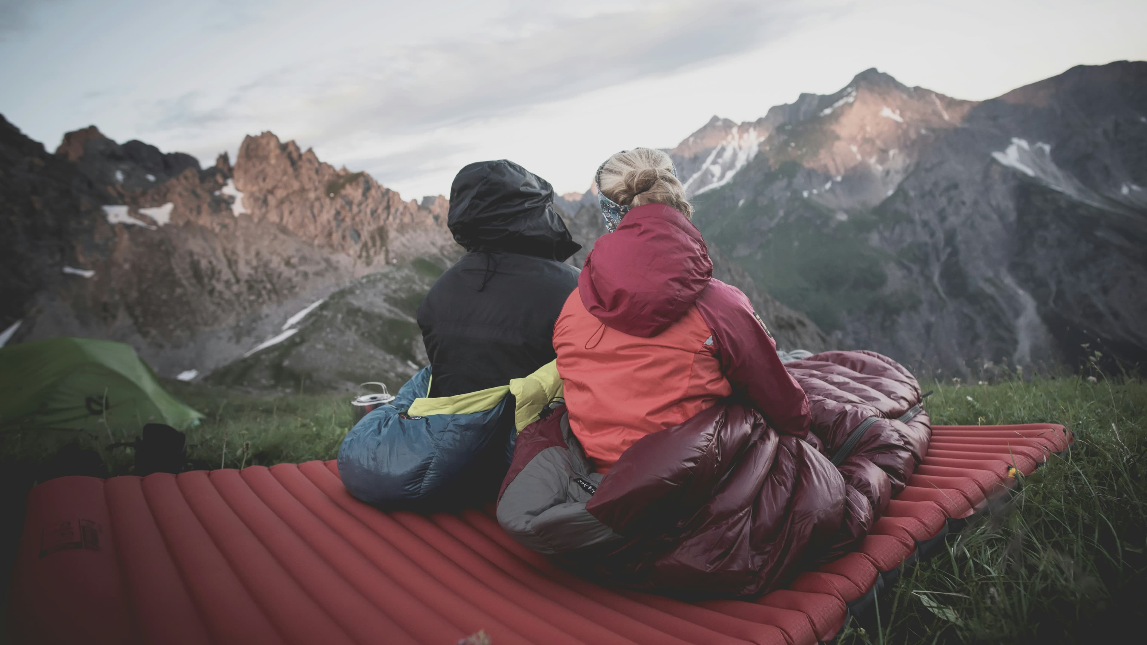 Sleeping bag laid out at a campsite in the mountains